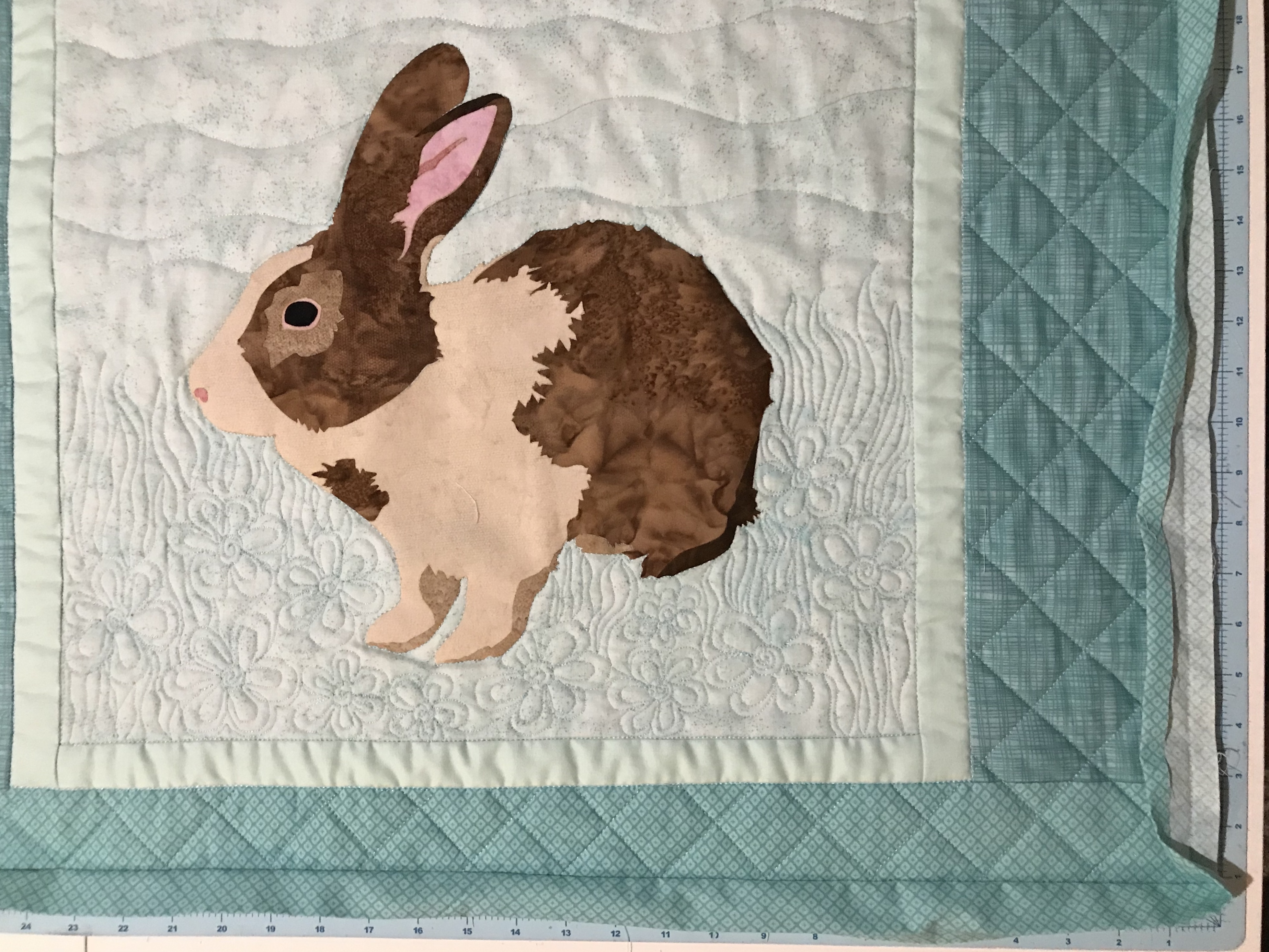 Brown Bunny wall quilt quilted and the binding ready for hand stitching.