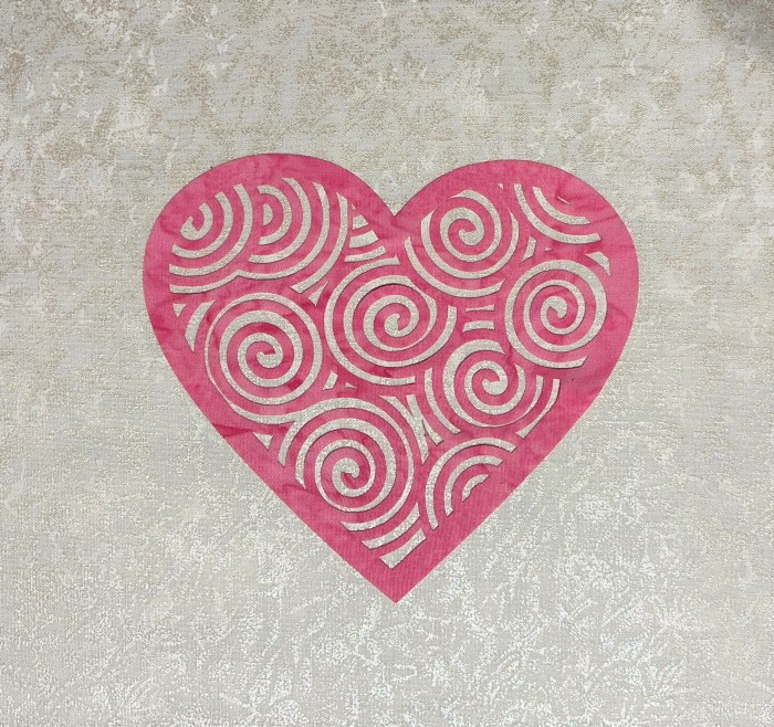 Photo of Pink Fussy Heart with design of swirls cut out of the middle.